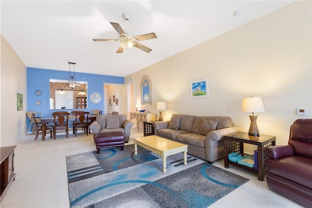 carpeted living room with ceiling fan