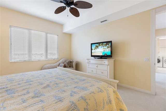 carpeted bedroom with ceiling fan and washing machine and clothes dryer