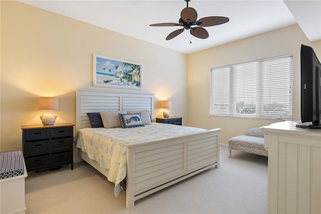 bedroom featuring light carpet and ceiling fan