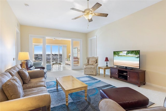 living room featuring light carpet and ceiling fan