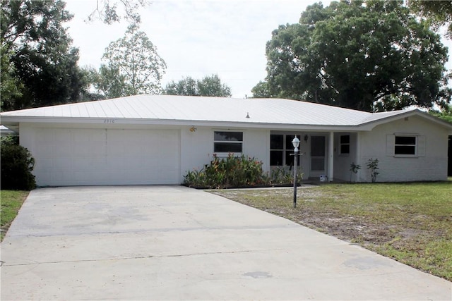 2910 59th Ave, Vero Beach, FL 32966 - ranch-style house featuring a garage, driveway, stucco siding, and a front yard