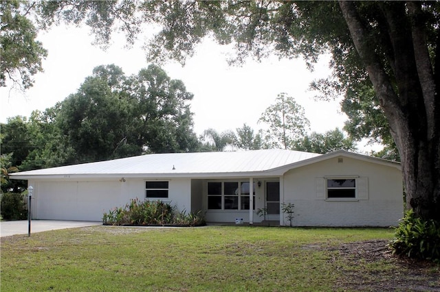 2910 59th Ave, Vero Beach, FL 32966 - ranch-style home with an attached garage, stucco siding, concrete driveway, and a front lawn
