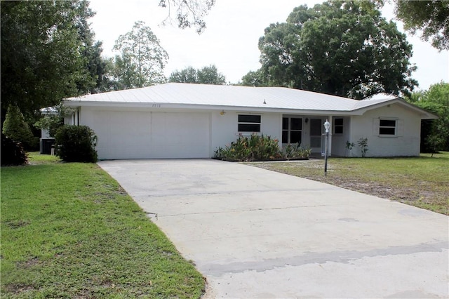 2910 59th Ave, Vero Beach, FL 32966 - ranch-style house featuring a garage, concrete driveway, stucco siding, and a front lawn