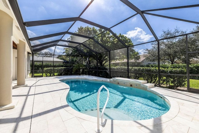 view of swimming pool with pool water feature, a patio area, and glass enclosure