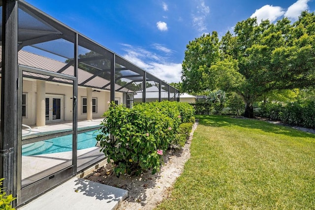 1765 E Rosewood Ct, Vero Beach, FL 32966 - outdoor pool featuring a patio, a yard, glass enclosure, and french doors