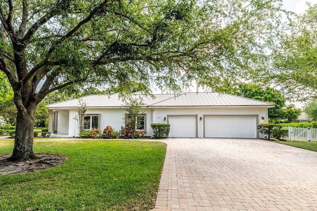1765 E Rosewood Ct, Vero Beach, FL 32966 - ranch-style house with stucco siding, an attached garage, decorative driveway, and a front lawn