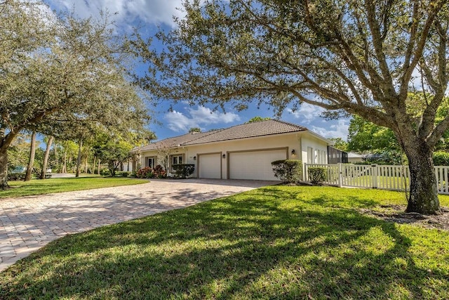 ranch-style home with a garage and a front yard