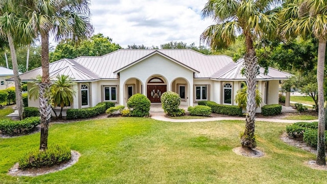 1765 E Rosewood Ct, Vero Beach, FL 32966 - view of front facade with a standing seam roof, a front yard, and metal roof