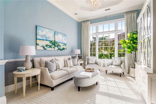 interior space featuring a raised ceiling, crown molding, and an inviting chandelier