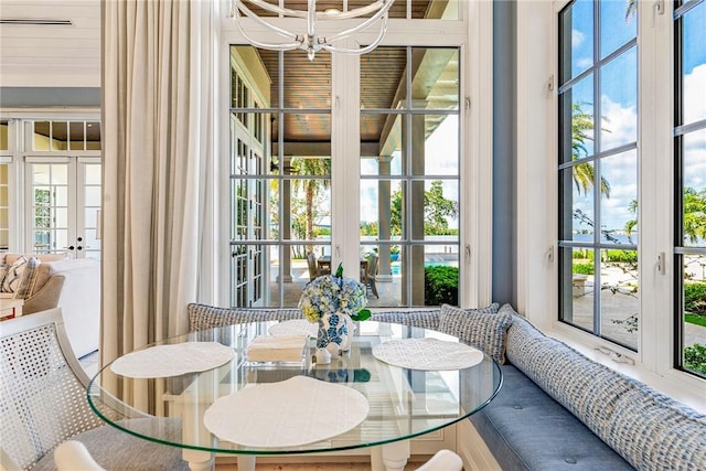 dining room with a healthy amount of sunlight, french doors, and an inviting chandelier