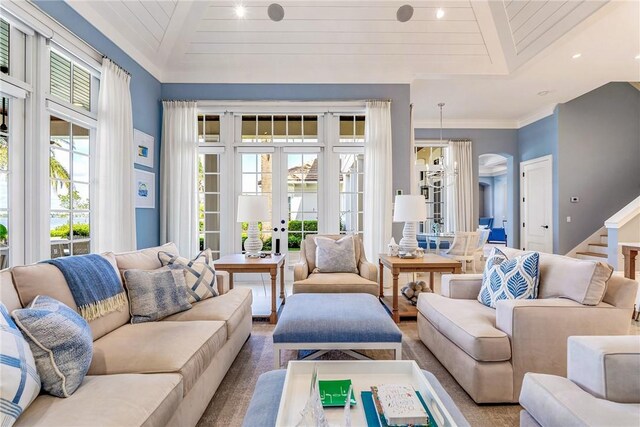 living room featuring crown molding, wooden ceiling, and sink