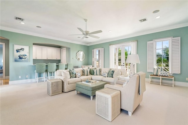 carpeted living room featuring ceiling fan and ornamental molding