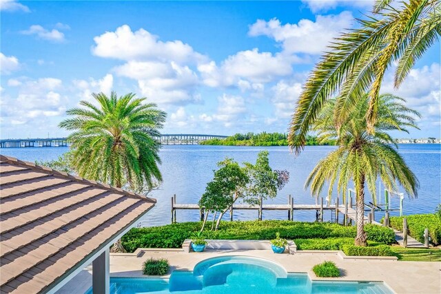 view of pool featuring a patio and a water view