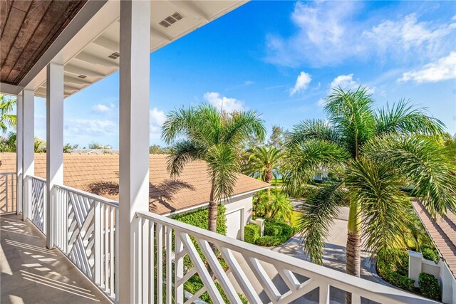 rear view of property featuring french doors, ceiling fan, a balcony, a patio area, and an outdoor fire pit