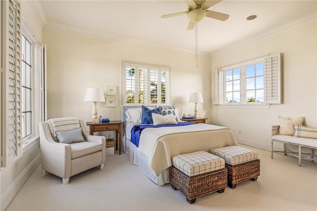 bedroom with carpet flooring, ceiling fan, crown molding, and multiple windows