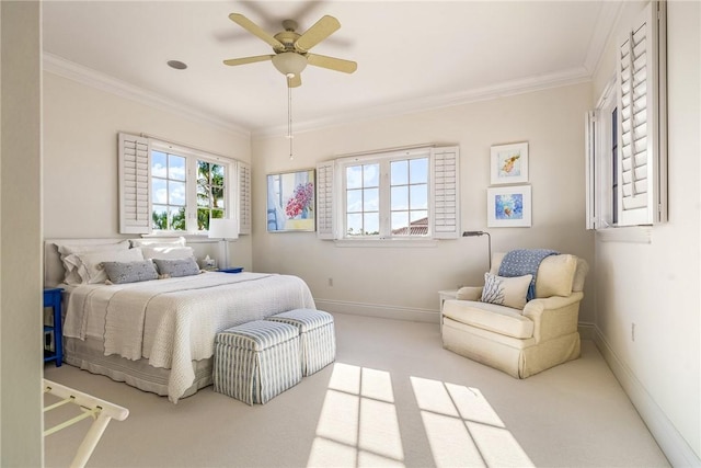 carpeted bedroom featuring ceiling fan and ornamental molding