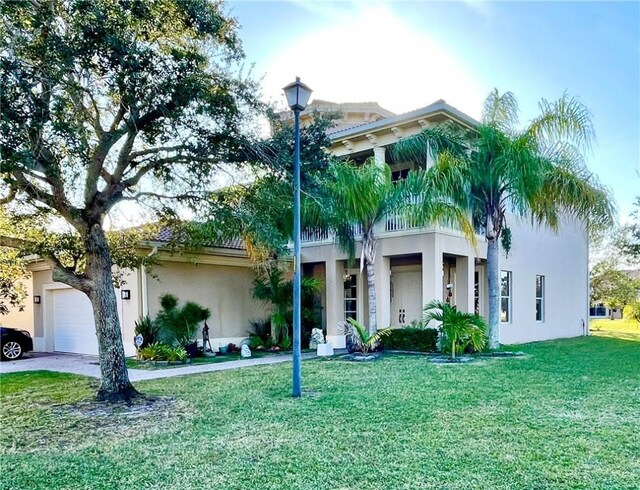 view of front of property featuring a garage and a front yard