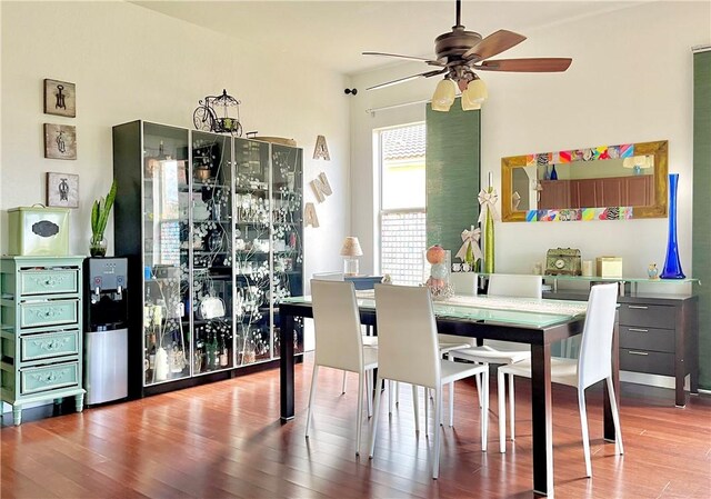 kitchen with tasteful backsplash, a breakfast bar, dark hardwood / wood-style flooring, and appliances with stainless steel finishes