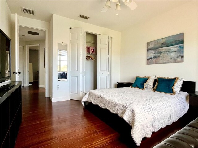 bedroom with a closet, ceiling fan, and dark wood-type flooring