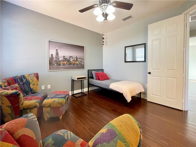 bedroom featuring ceiling fan and dark hardwood / wood-style floors