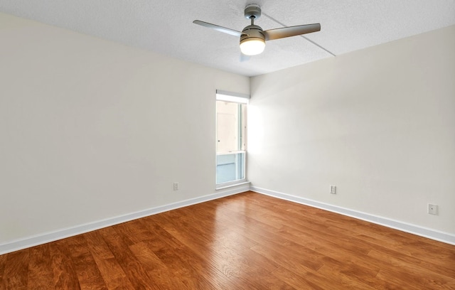 spare room with hardwood / wood-style floors, ceiling fan, and a textured ceiling