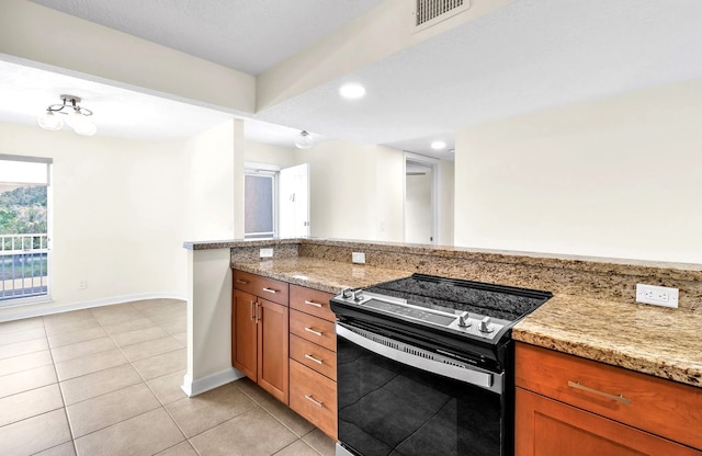 kitchen featuring stainless steel electric stove, light stone countertops, and light tile patterned flooring