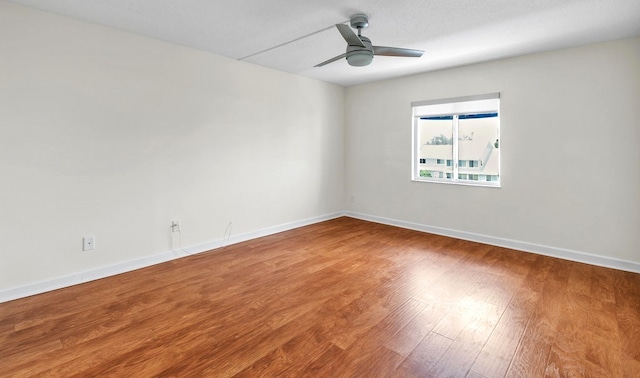 unfurnished room with hardwood / wood-style flooring and ceiling fan