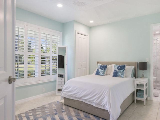 bedroom with light tile patterned floors, baseboards, connected bathroom, and recessed lighting