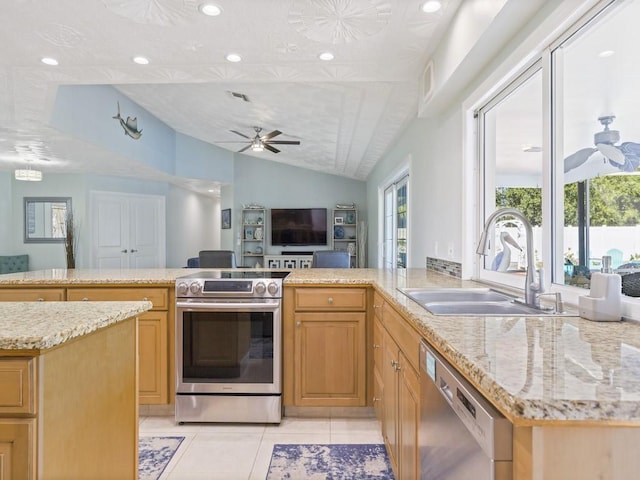 kitchen with a ceiling fan, light tile patterned floors, appliances with stainless steel finishes, and a sink