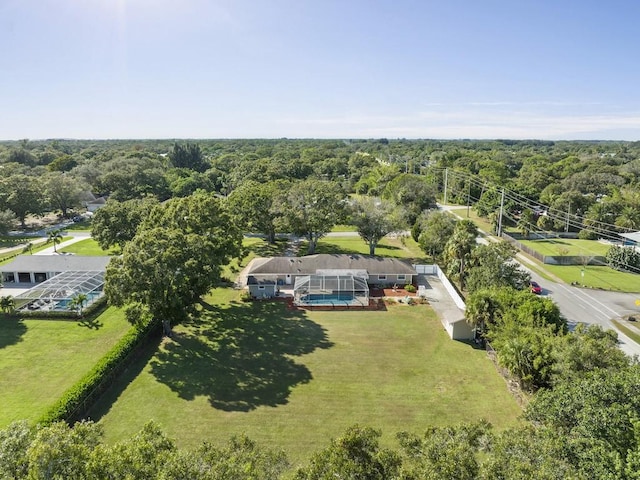 drone / aerial view with a wooded view