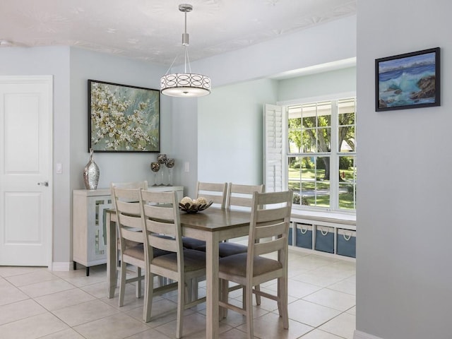 dining space featuring baseboards and light tile patterned floors