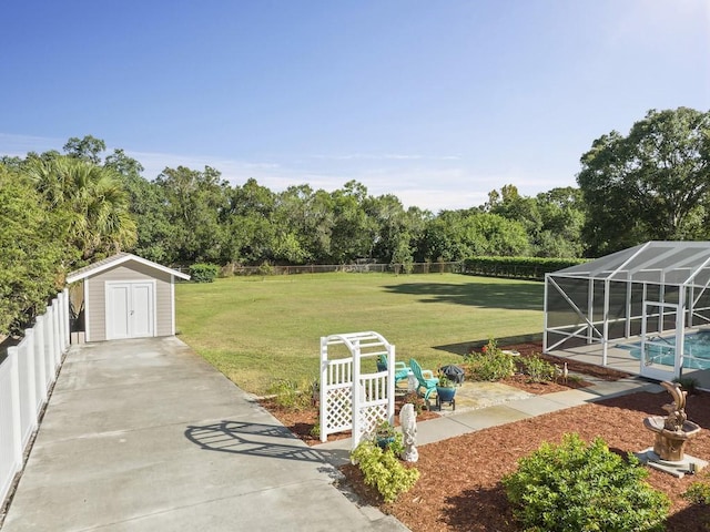 view of yard with a lanai, a patio area, a fenced backyard, and an outdoor pool