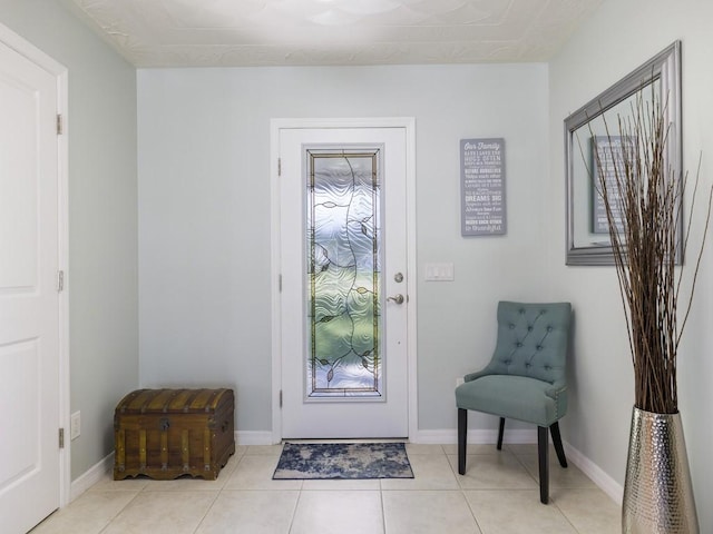 entryway with light tile patterned floors and baseboards