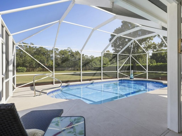 pool featuring a patio, a yard, and a lanai