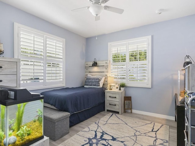 bedroom featuring light wood-type flooring, ceiling fan, and baseboards