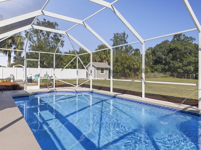 view of pool featuring a lawn, glass enclosure, a shed, a fenced backyard, and an outdoor structure