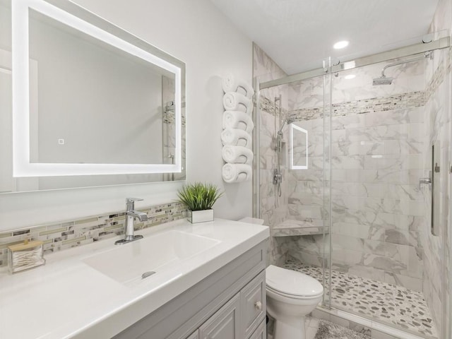 bathroom with tasteful backsplash, recessed lighting, toilet, a stall shower, and vanity