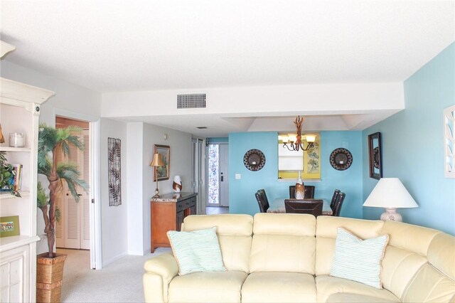 3939 Ocean Dr Unit 205C, Vero Beach, FL 32963 - living area featuring light carpet and a chandelier