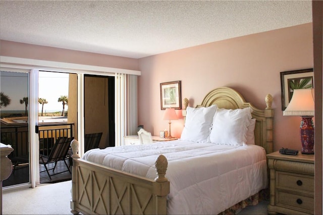 3939 Ocean Dr Unit 205C, Vero Beach, FL 32963 - carpeted bedroom featuring access to outside and a textured ceiling