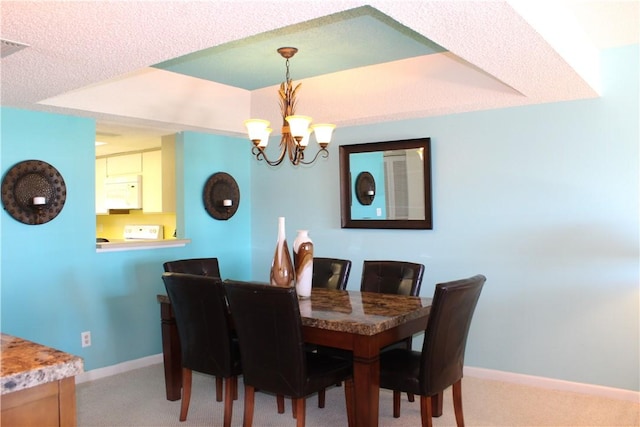 3939 Ocean Dr Unit 205C, Vero Beach, FL 32963 - dining space with light colored carpet, a chandelier, and baseboards
