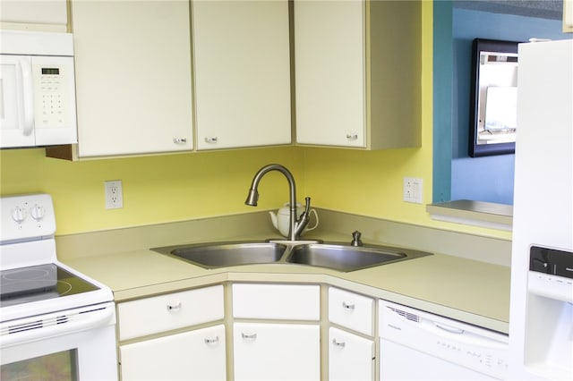 kitchen featuring white appliances and white cabinetry