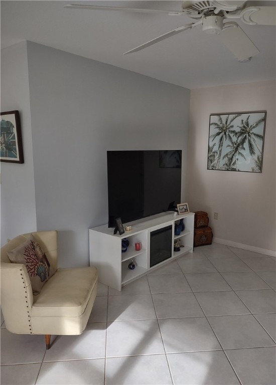 living room featuring ceiling fan and light tile patterned floors