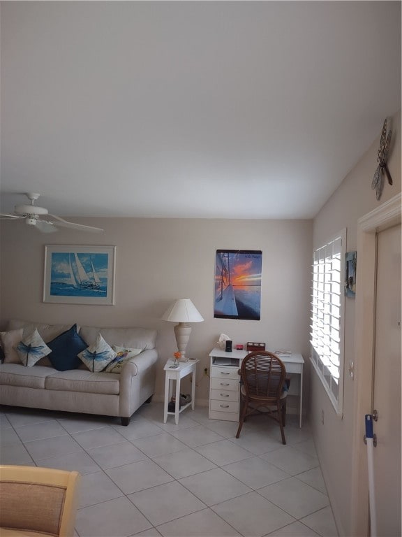 living room featuring ceiling fan and light tile patterned floors