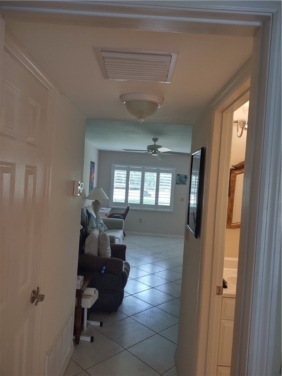 corridor with light tile patterned floors