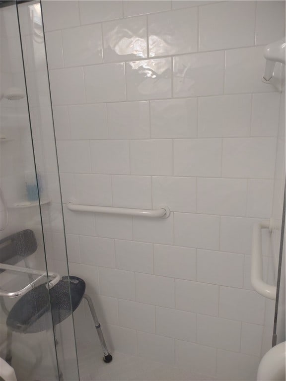 bathroom with a shower with shower door