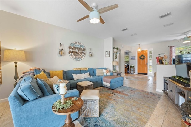 tiled living room featuring ceiling fan