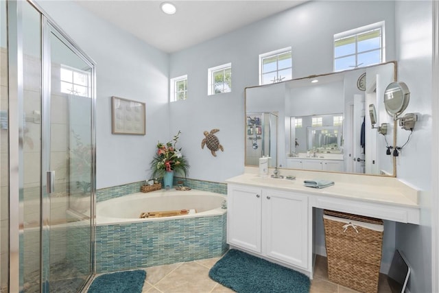 bathroom with tile patterned floors, vanity, and plus walk in shower