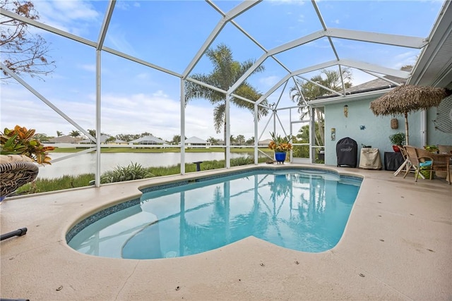 view of swimming pool with glass enclosure, a water view, and a patio