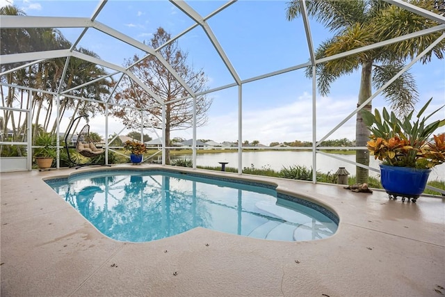 view of pool featuring glass enclosure, a water view, and a patio