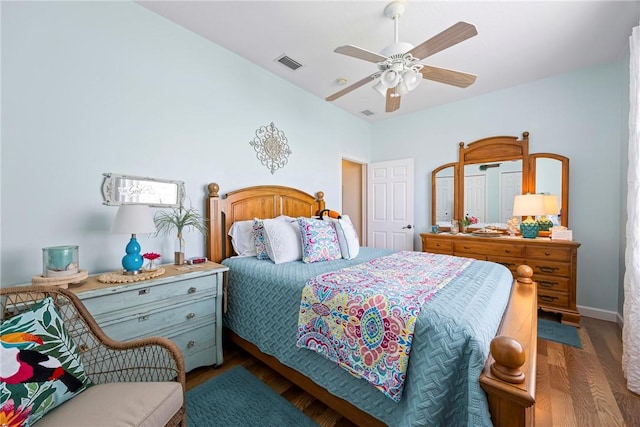 bedroom with ceiling fan and dark hardwood / wood-style flooring